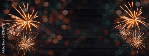 HAPPY NEW YEAR - Sylvester, New Year's Eve 2023 Party, New year, Firework celebration background banner panorama - Orange fireworks and bokeh lights on dark rustic wooden wall texture in the night.