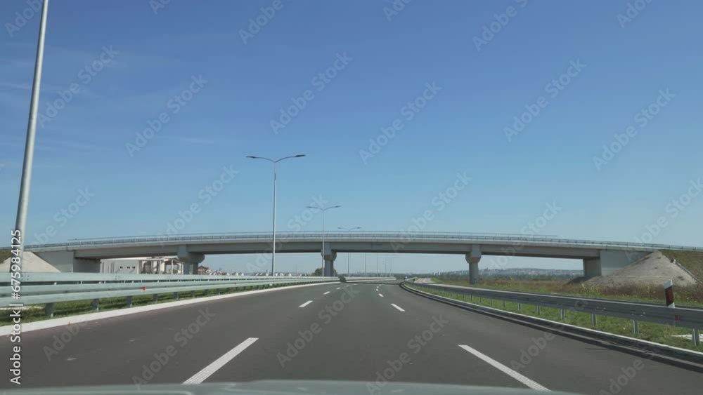 Front view driving on highway under a passage