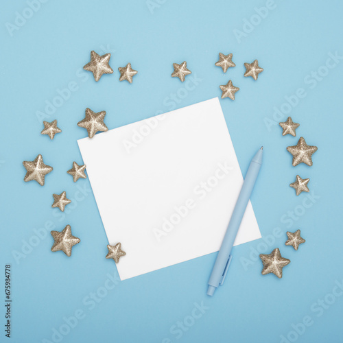 Blank greeting card for your text with pen and decorative stars on cyan background photo