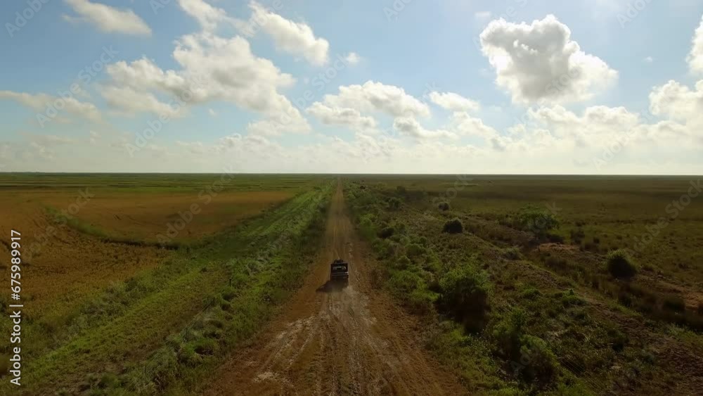 Aerial Forward Shot Of Atv Moving On Dirt Road In Farm Against Sky - Bayou, Louisiana Aerial Forward Shot Of Atv Moving On Dirt Road In Farm Against Sky - Bayou, Louisiana