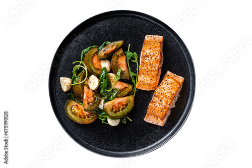 Grilled Salmon Fillet Steaks with arugula and tomato salad on a plate.  Transparent background. Isolated