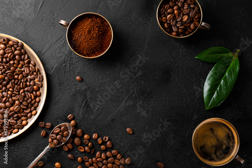 Coffee background - cup of black coffee, coffee beans and ground coffee on a black background top view, copy space for text