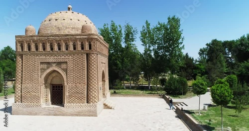 A drone flies near a Ismoil Somoniy madrasah on a sunny day. Uzbekistan, Bukhara. photo