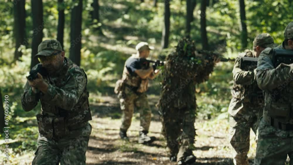 Soldiers Move Quickly Through the Forest and Observe the Surroundings Soldiers Move Quickly Through the Forest and Observe the Surroundings