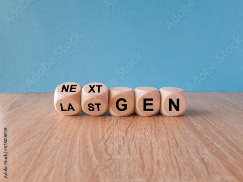 Symbol for the next generation. Turned a cube and changes the expression last gen to next gen. Beautiful blue background. Wooden table