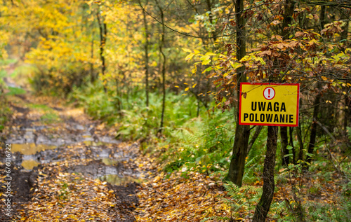 a sign in the forest warning about hunting