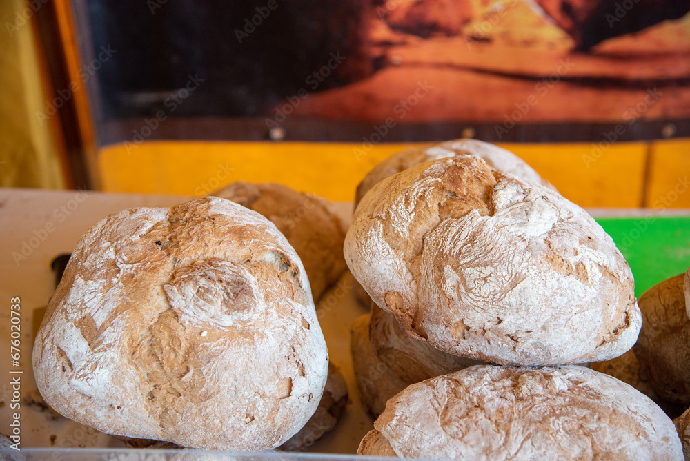 Detail shot of some loaves of bread that have been produced in an artisan way and are exhibited in the street market of food and artisan products typical of the Mediterranean diet.