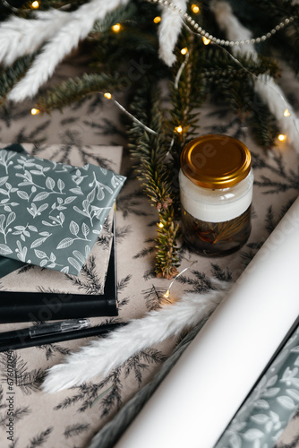 Festive decor with paper wrap, presents and a handmade candle.