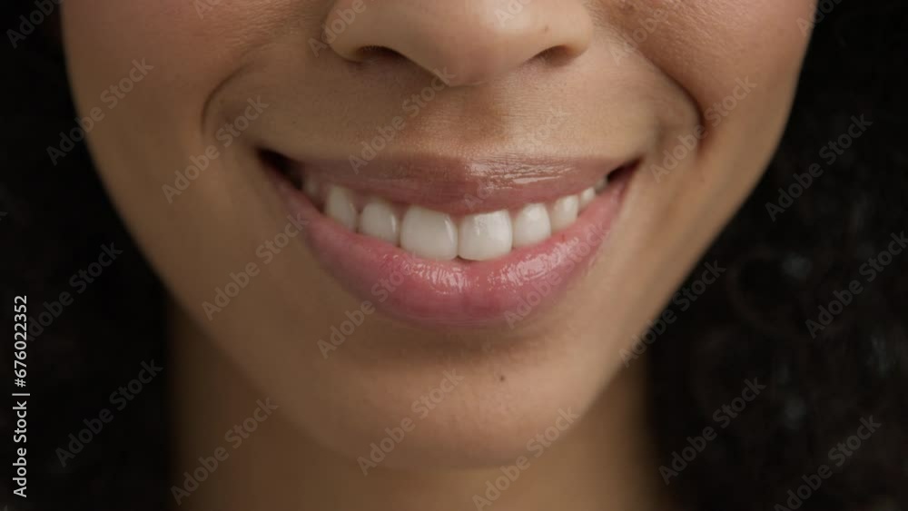 Woman mouth slow motion. Perfect soft skin sexy multi racial diverse model smiling kiss 4K. Lips kiss in natural day light. Beauty sexy female model with dark skin and full glossy pink lips closeup. Woman mouth slow motion. Perfect soft skin sexy multi racial diverse model smiling kiss 4K. Lips kiss in natural day light. Beauty sexy female model with dark skin and full glossy pink lips closeup.
