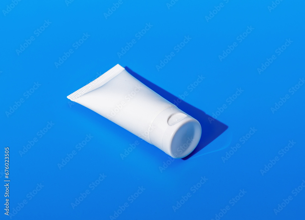Cream tube mock up, small cosmetic mini package mockup on blue Cream tube mock up, small cosmetic mini package mockup on blue