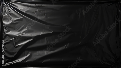 Polythene wraps for an overlay effect on black background. Wrinkled packaging photo