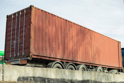 Container on truck. Transportation of goods by road. Large container of red color.