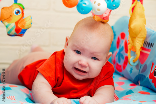 Portrait of cute baby a newborn girl playing in the room