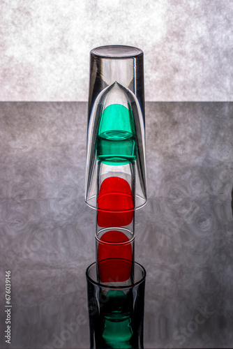 Still life with glass objects with colored spots on a reflective surface