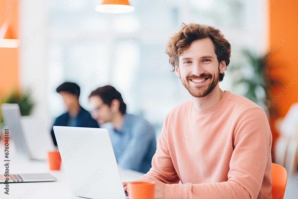 Business professional guy in a modern office working with a smile on his face.