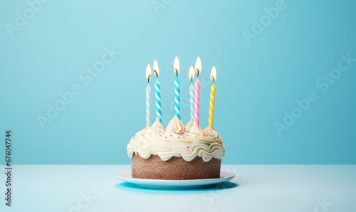 birthday cake with six 6 candles on pastel blue background with copyspace