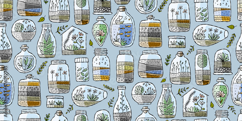 Florarium in bottle set with cactuses, succulents, leaves, branches, stones a...