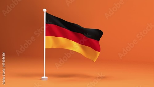 Elegant German Flag on a Stand with a Warm Orange Background. Beautiful German flag on a white flagpole.