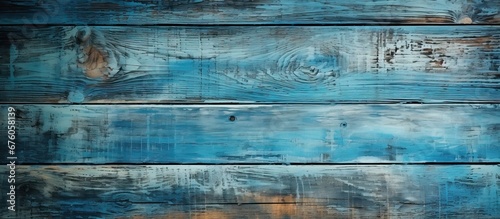 In France the vintage barnwood wall painted with a blue grunge color creates an abstract pattern giving a textured and abstract design that adds a nostalgic touch to the background photo
