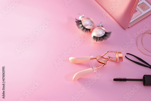 False eyelashes and curler tool cosmetics, Christmas decoration, pinkbackground