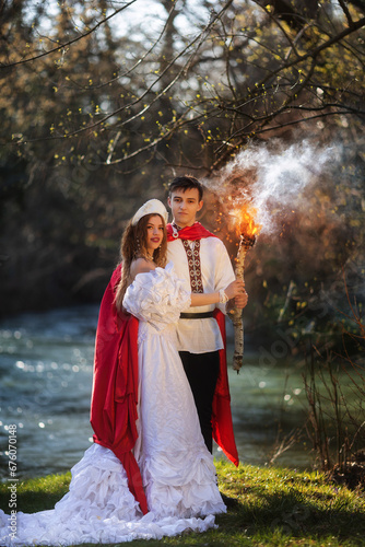 pair of lovers in Russian folk style. man and woman near the river photo