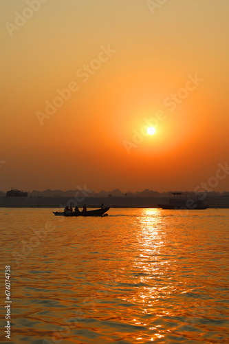 The sun rises over the eastern riverbank of the Ganges River near Varanasi India. © Daniel Meunier