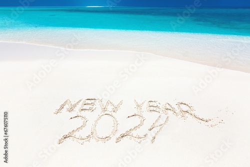 Fototapeta Naklejka Na Ścianę i Meble -  Inscription word NEW YEAR and numbers 2024 on sandy beach
