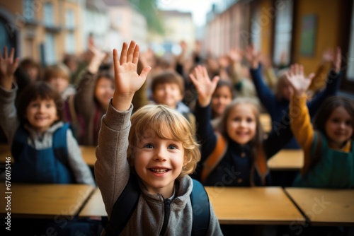 Group of school kids raising hands in classroom.