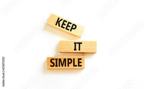 Keep it simple symbol. Concept word Keep it simple on beautiful wooden block. Beautiful white table white background. Business motivational keep it simple concept. Copy space. photo