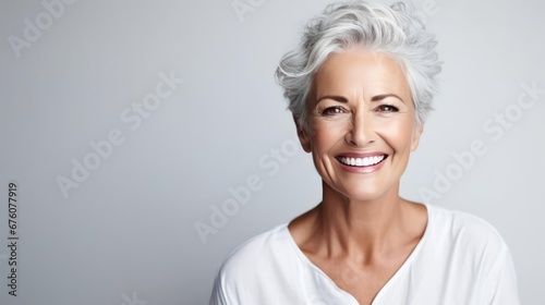 Beautiful gorgeous 50s mid age beautiful elderly senior model woman with grey hair laughing and smiling Mature old lady close up