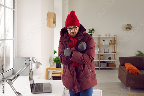 Fotografija Man is wearing warm clothes indoors during a very cold winter