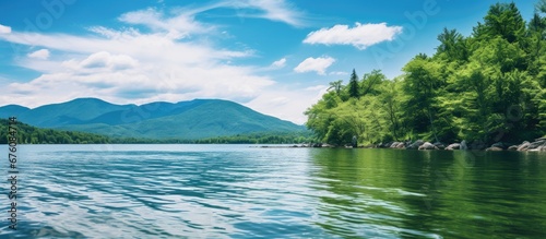 During the summer travelers flock to Vermont to immerse themselves in the breathtaking landscape adorned with vibrant green trees crystal clear waters and a pristine white cloud studded sky 