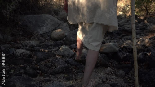 Low follow shot of a Bible prophet walking in the wilderness