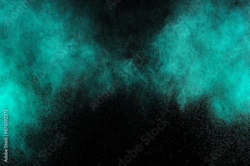 Aquamarine powder explosion on black background. Colored powder cloud. Colorful dust explode. Freeze motion paint Holi.