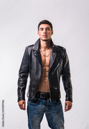 A man in a leather jacket posing for a picture