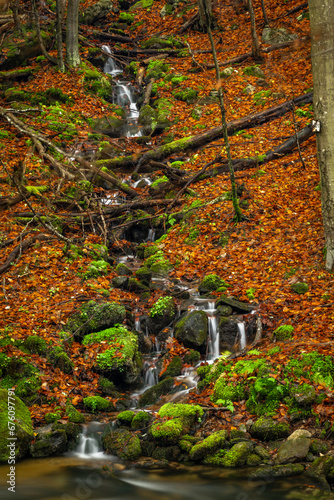 Small creek from hillside near Ponikly waterfall after rain in autumn morning