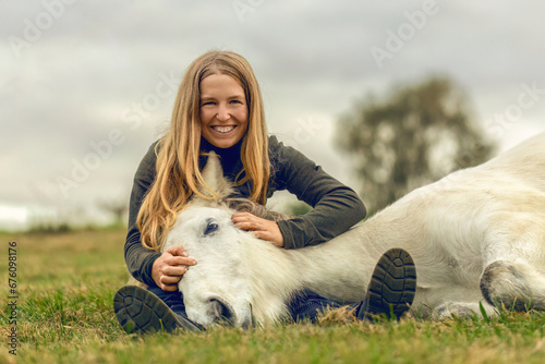 A young woman and her icelandic horse working and cuddle together, equestrian natural horsemanship concept