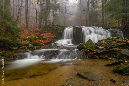 Ponikly waterfall with flood water after night rain in autumn morning