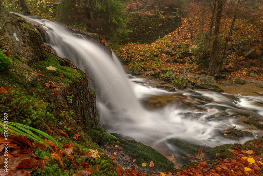 Ponikly waterfall with flood water after night rain in autumn morning