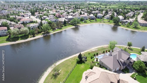 Aerial footage of Briarwood, Saskatoon, SK, highlighting its elegant homes, winding streets, and green parks. A tranquil suburban escape, perfect for real estate visuals. photo