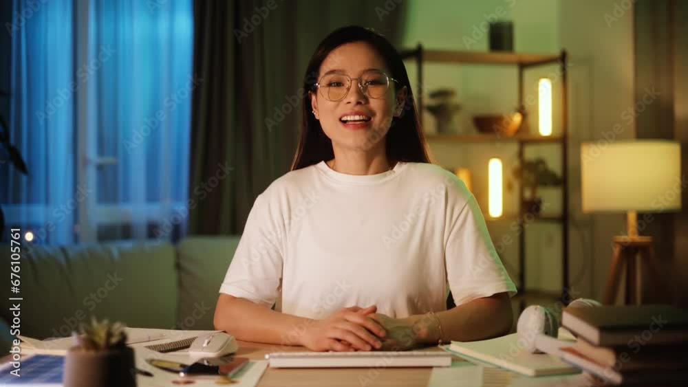 Camera view of young asian woman having video call conference meeting interview by laptop computer at home Confident female talking on working conversation having distance remote job at night indoors Camera view of young asian woman having video call conference meeting interview by laptop computer at home Confident female talking on working conversation having distance remote job at night indoors