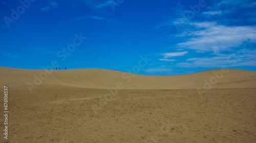 desert dunes skyline in front of blue sky 