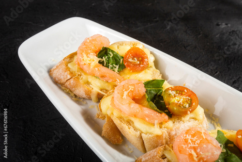Shrimp bruschetta sauteed in wine on French bread with Neapolitan sauce, basil, mozzarella cheese, cherry tomatoes