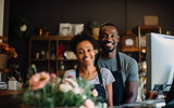 Cheerfull black couple working as a cashiers in the store