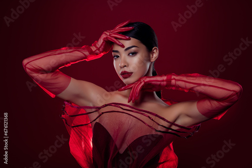 Photo of lovely asian girl femme fatale seductive model high fashion shoulders off isolated dark red color background