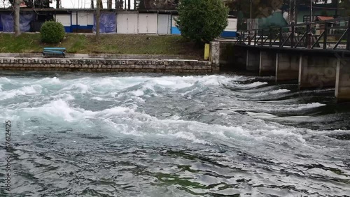 Rippled waters quickly flow out of Lake Ohrid under the wooden bridge in Struga, Macedonia and this is where the Crn Drim River is born. 