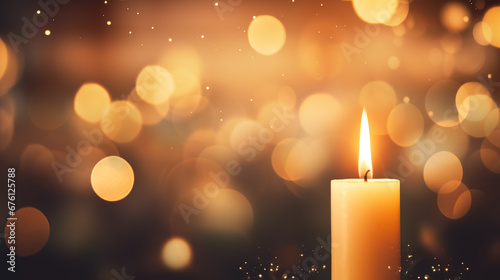 Single candle with golden bokeh background.