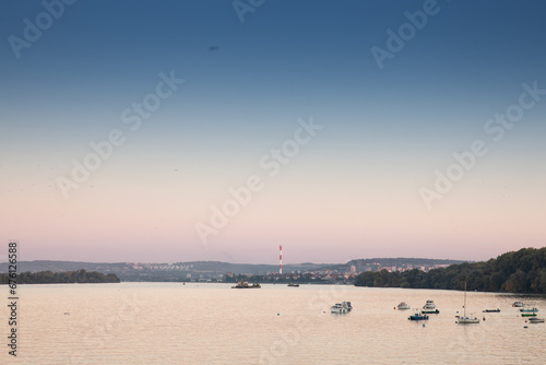 Zemun Quay (Zemunski Kej) in Belgrade, Serbia, on the Danube river, seen in autumn, at sunset. Boats can be seen in front, and Belgrade center in background