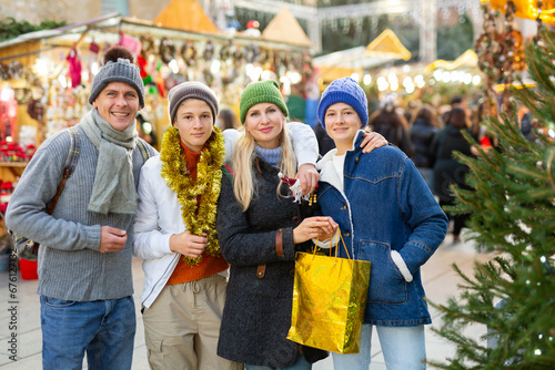 Portrait of a happy family with teenage children who came to an open-air Christmas fair