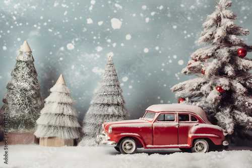 Miniature red car on winter snowing background